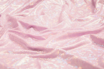 Fototapeta na wymiar Selective focus of pink textile background. Textured shiny retro decoration design