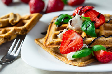 Belgium waffles dessert with strawberries, ricotta cheese and chocolate. Selective focus.