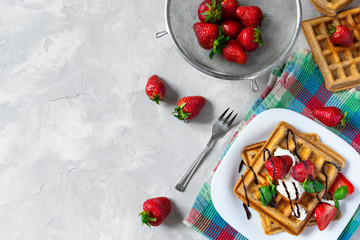 Naklejka na ściany i meble Homemade waffles with strawberries, ricotta cheese and chocolate on white plate. Flat lay, copy space