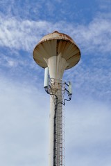 Water tower with clouds in sky