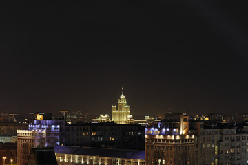 Fototapeta na wymiar View of Moscow at night and high-rise building on the Kotelnicheskaya Embankment. One of seven Stalin skyscrapers