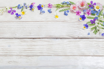 beautiful flowers on wooden background