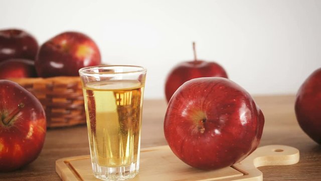 close up  apple cider vinegar with fresh red apple fruit on table , pan shot , healthy food for weight loss, reduced cholesterol, lower blood sugar levels