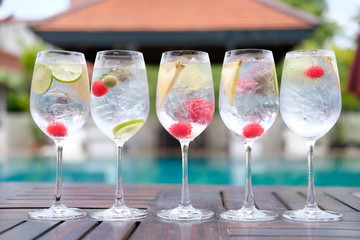 Summer drinks gin tonic in wine glasses at poolside bar