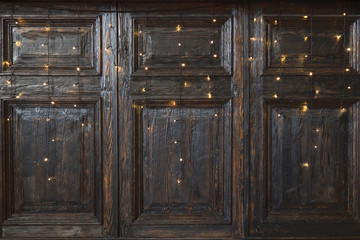 Vintage wooden wall with garlands. Wooden wall decorated by electric lamps