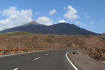 Rotate the road with blur in the foreground while driving and mountains with a volcano in the background