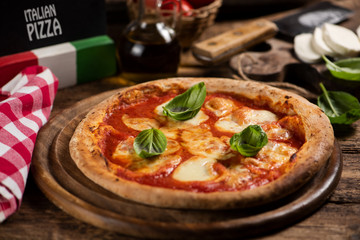 Italian pizza Margherita on a wooden table
