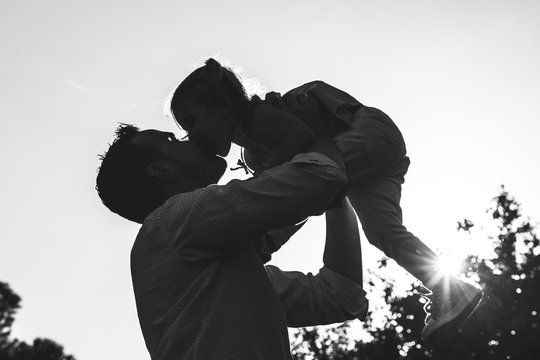 Divorced Father Playing With His Daughter Outdoors.