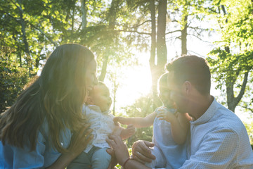 Happy Hispanic Family Having Fun Together Outdoors.