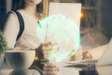 Social network theme hologram over hands taking notes background. Concept of global international people connect. Double exposure