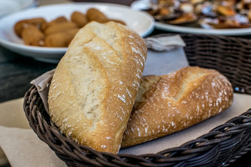 basket of bread on a table and delicious tapas on the table. Selective focus