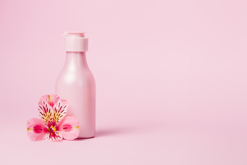 Obraz na płótnie Canvas Creative minimal beauty and health background with pink bottle