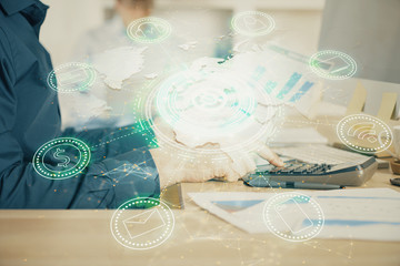 Social network theme hologram with businessman working on computer on background. Multi exposure.