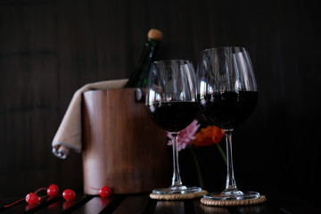 Close up wine glasses and bottles on wooden background