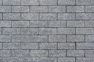 Top view on a gray pavement of granite tiles (texture, background)