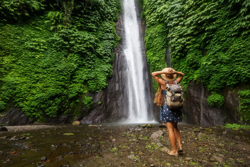 Fototapeta na wymiar Woman near Munduk waterfal on Bali, Indonesia