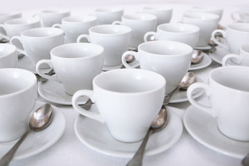 White dishes: cups and saucers for tea or coffee on a white background. Top and side view. Isolated object. A lot of dishes on a white background. A concept of still life.