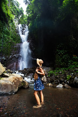 Woman near waterfal on Bali, Indonesia 