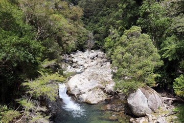 Naklejka premium Rocks and water landscape, on the way to Wainui falls track, Golden Bay, New Zealand