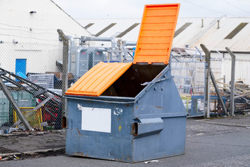 Skip and orange lid open for rubbish and waste disposal for recycling