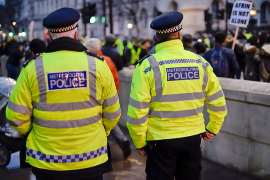 London English Police Officer At Work On Street