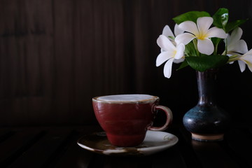 coffee cup with fresh milk on wooden table