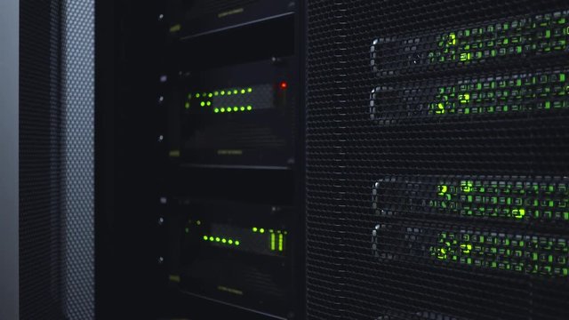 Network server room with racks in data center. Blink Led lamp. Dark server room.