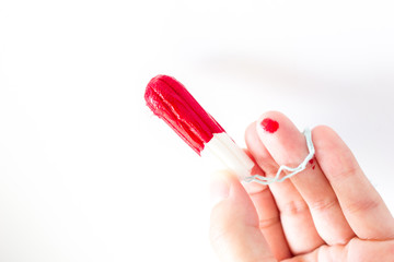 Female hand holding hygienic tampon on white background, close up