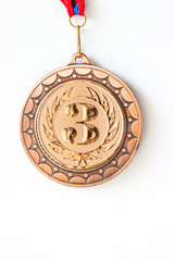 Gold silver bronze medals. Champion winner of the metallic medal award, close-up on a white background.