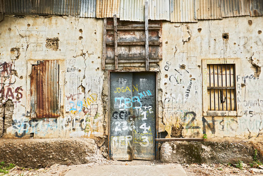 Puerto Princesa City, Palawan, Philippines: Close-up view of the front of an abandoned ruined building with closed windows and door