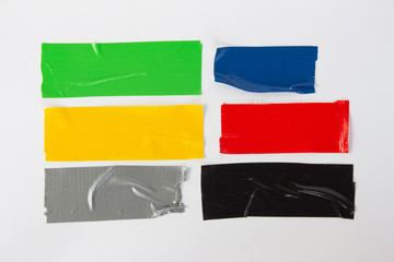 Set of gray, green, black, yellow, red, blue tapes on white background. Torn horizontal and...