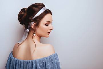 Portrait of young cheerful woman, over grey background