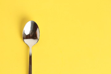 silver spoon isolated on colorful background