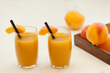 two peach juice glasses on white