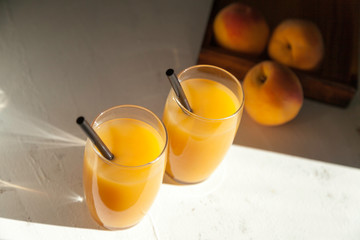 two peach juice glasses with shades