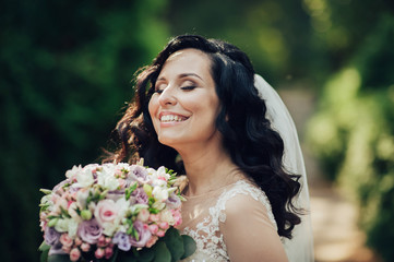 Beautiful bride and groom embracing and kissing on their wedding day.