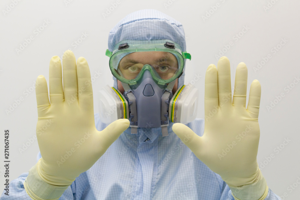 Poster An engineer of laboratory wearing a special uniform and protective glasses and face mask against chemical poison show gesture by hands sign STOP