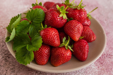 Fresh juicy strawberry on a concrete background. It can be used as a background