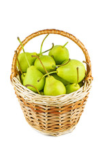 Fresh green pears in wicker baskets isolated on white background
