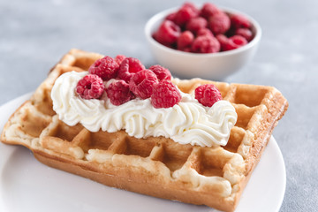 Homemade waffle with raspberries and cream