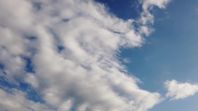 Beautiful blue sky intime lapse with scenic altocumulus white clouds running in the air