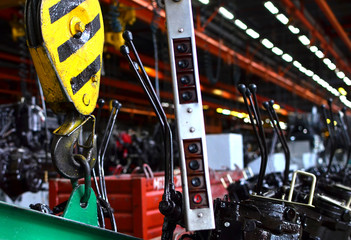 Bridge lifting Crane Hook against the background of the Assembly Line industrial factory. The...