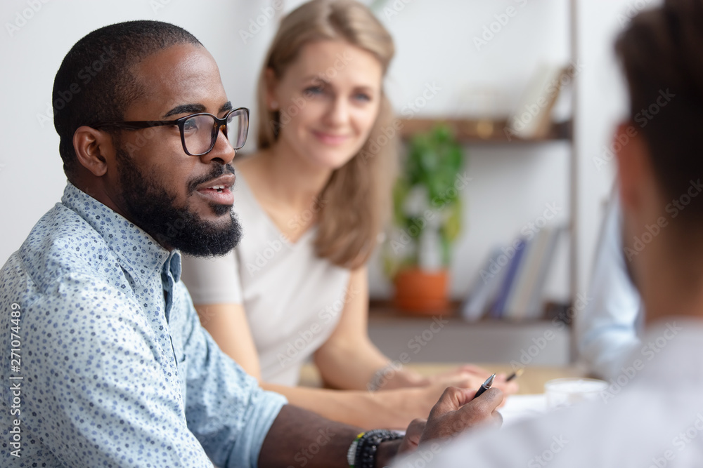 Sticker Male african-american talking to coworkers timeout in office