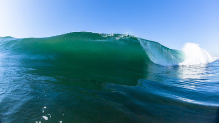Fototapeta na wymiar Ocean Swimming Inside Hollow Crashing Wave Closeup Water Photo