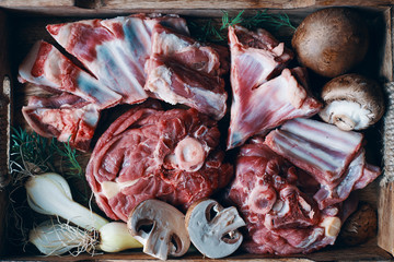 A box of raw lamb meat and vegetables top view 