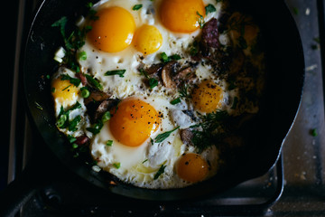 Hot homemade fried eggs with sausage, mushrooms and herbs top view space for text 