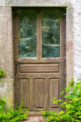 old wooden door of an abandoned house