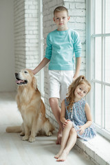 Beautiful children with a dog.