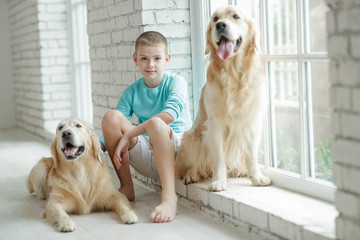 A boy with a dog at home.