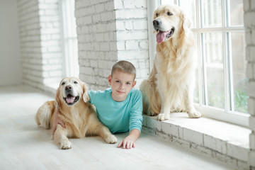 A boy with a dog at home.